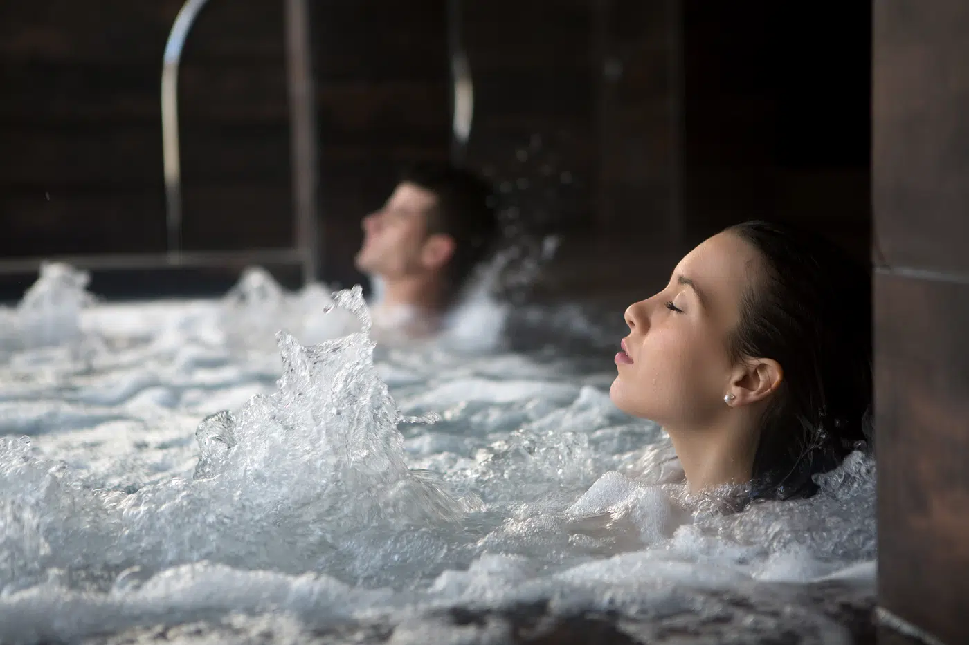 Bathers unwinding in a warm microbubble hydrotherapy pool