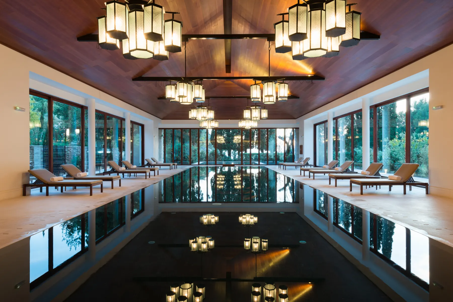 Destination spa indoor lap pool with warm lantern lighting