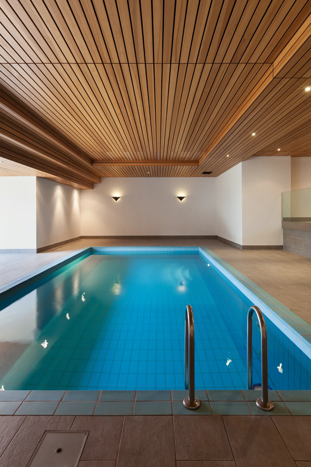 Minimalist indoor lap pool with clear, well-managed water